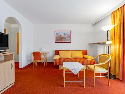 a living room with a couch and chairs at Landhotel Gabriele in Unterwössen