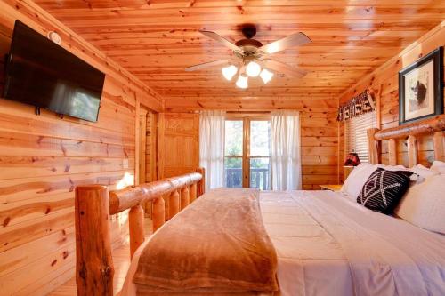 a bedroom with a bed in a log cabin at Sleepy Willow Cabin in Sevierville