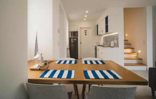 a kitchen and dining room with a wooden table and chairs at Villa Mar - Maia in Maia