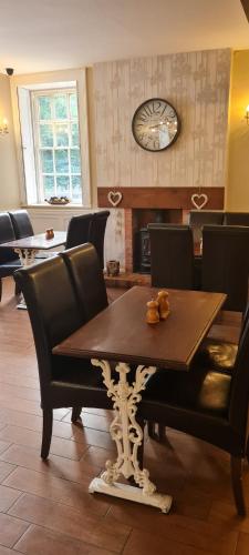 a dining room with a wooden table and chairs at The Family Tree in Whatstandwell