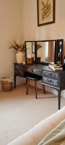 a desk with a large mirror on top of it at The Family Tree in Whatstandwell