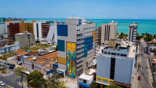 a city with a building with a mural on it at ibis budget Maceió Pajuçara in Maceió