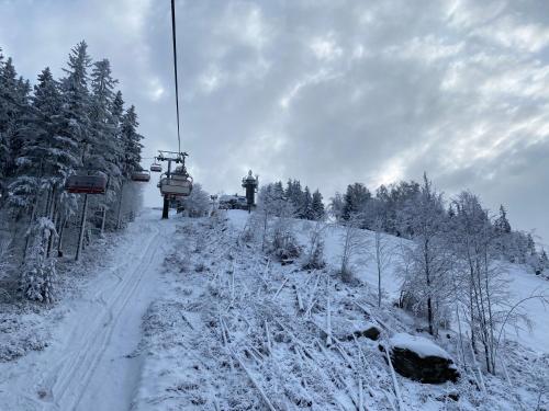 a ski lift going up a snow covered slope at Slunný byt v Jizerských horách 5 postelí in Tanvald