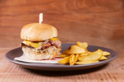 a sandwich and french fries on a plate at Rifugio Cereda in Fiera di Primiero