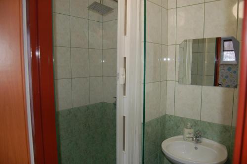 a bathroom with a sink and a shower at Leśne Zacisze in Weremień