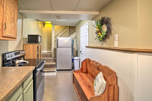 a kitchen with a refrigerator and a bench in it at Beckley Studio with Hot Tub, 4 Mi to WVU Tech! in Beckley