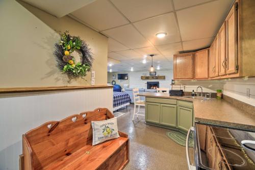 a kitchen with a bench in the middle of a room at Beckley Studio with Hot Tub, 4 Mi to WVU Tech! in Beckley