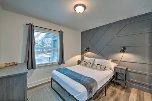 a bedroom with a large bed and a window at Modernized SLC Duplex with Yard about 4 Mi to Dtwn! in Salt Lake City