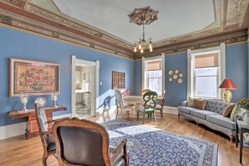 a living room with blue walls and a couch and a table at Charming Mt Pleasant Home in Historic Dtwn! in Spring City