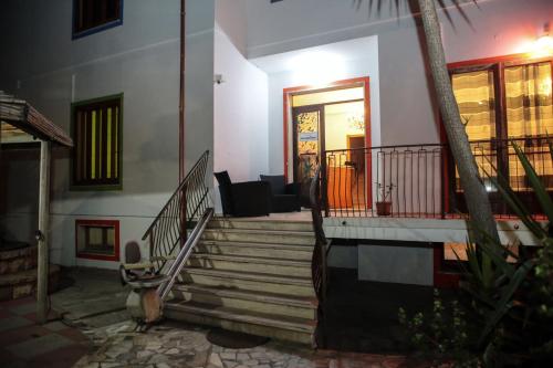 a house with stairs leading to a door at Hotel I Colori in SantʼAntìoco
