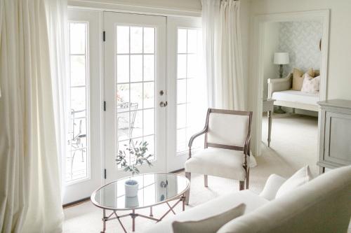 a living room with a couch and a glass table at Fairville Inn in Chadds Ford