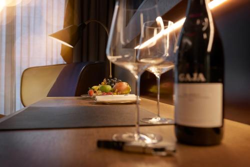 a bottle of wine and a plate of food on a table at BEYOND by Geisel - Adults only in Munich