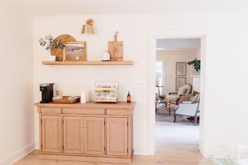 a living room with a wooden cabinet in a room at Fairville Inn in Chadds Ford