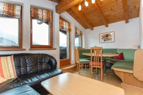 a living room with a couch and a table at Gästehaus Dreier in Neukirchen am Großvenediger