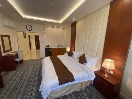 a hotel room with a large bed and a bathroom at نزل خيال للشقق المخدومه in Jazan