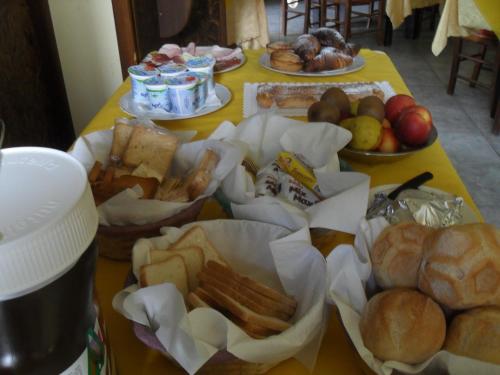 a table with bread and other foods on it at Mamma Assunta in Melendugno