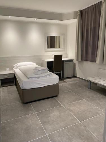 a bedroom with a bed and a desk and a table at Antica locanda al Gelso in Monfalcone