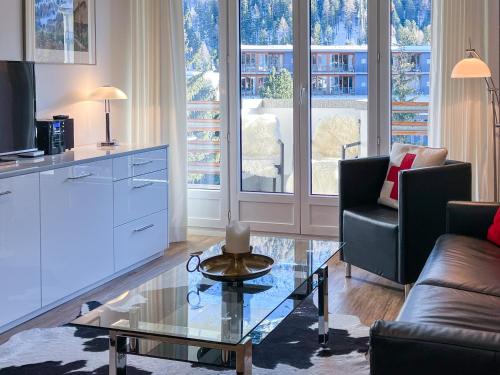 a living room with a couch and a coffee table at Designer Küche - Südbalkon - TG-Stellplatz - WLAN in St. Moritz