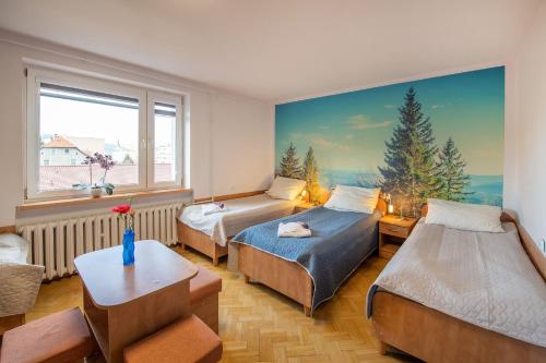 ロンデク・ズドルイにあるOśrodek Wypoczynkowy Bankowyのベッドルーム1室(ベッド2台付)が備わります。壁には絵画が飾られています。