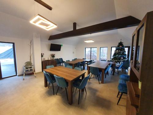 a dining room with tables and chairs and a christmas tree at Pensiunea Black Mountain in Baia-Sprie