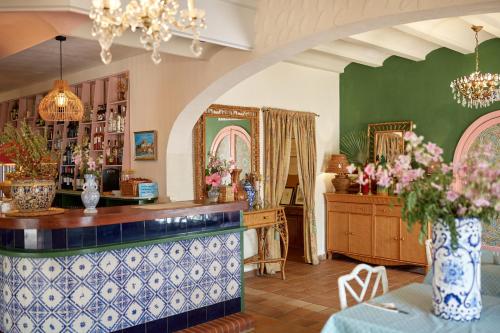a room with a counter with a vase of flowers on a table at El Cid Country Club in Benidoleig