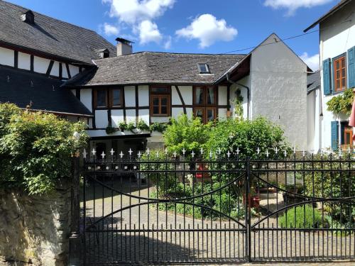 a black fence in front of a house at Gut Bunt Ferienhaus in Runkel