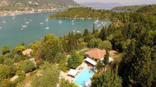an aerial view of a house and a lake with boats at Villa Nefeli in Yénion