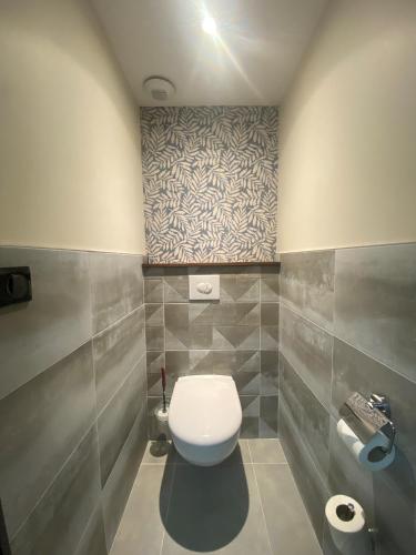 a bathroom with a white toilet in a room at Sure Hotel by Best Western Reims Nord in Reims
