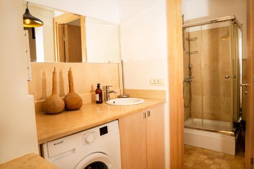 a bathroom with a sink and a washing machine at Villa Marlin in Kalkan