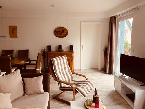 a living room with a couch and a chair at Ferienwohnung Könnecke Bad Harzburg in Bad Harzburg