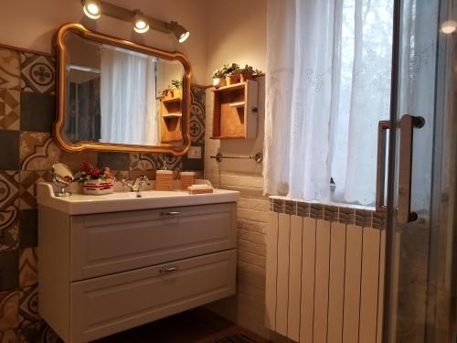 a bathroom with a sink and a mirror at Serena Country home in Capranica