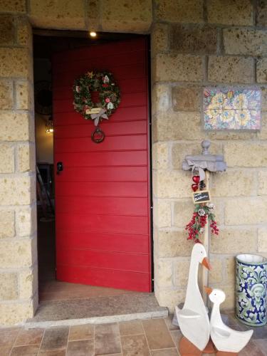 a red door with a christmas wreath on it at Serena Country home in Capranica