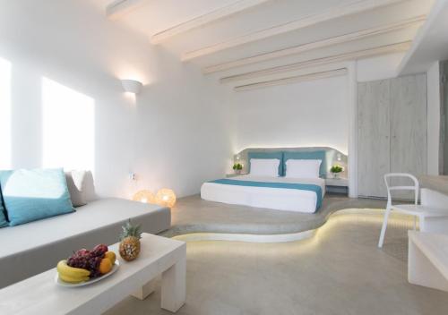 a bedroom with two beds and a table with fruit on it at Princess Of Naxos in Naxos Chora