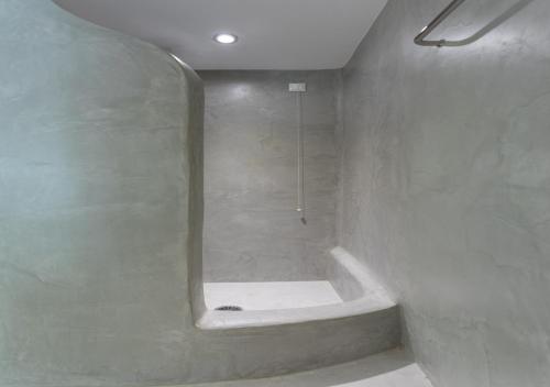 a bathroom with a bath tub with a mirror at Princess Of Naxos in Naxos Chora