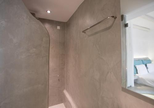 a bathroom with a shower with a mirror at Princess Of Naxos in Naxos Chora