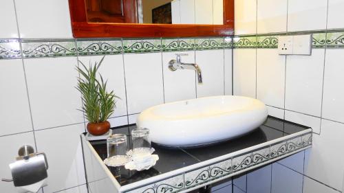 a white sink on a counter in a bathroom at Regina Beach Bungalow in Trincomalee