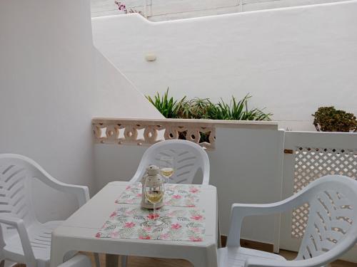 a white table and chairs with a tea kettle on it at MI ALMA in Puerto del Carmen