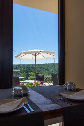 a table with a view of a patio with an umbrella at Ca Montiglio in Quagliuzzo