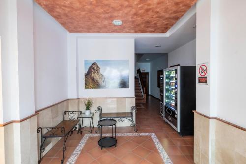 a hallway with a table and chairs in a building at Hotel Apartamentos Villa Gomera in San Sebastián de la Gomera