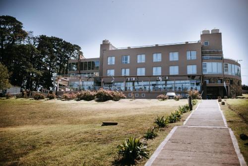 a large building with a field in front of it at Posta Natural in Tandil