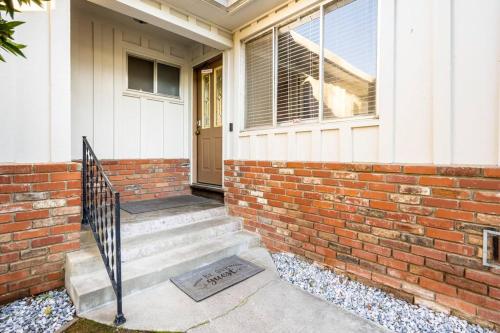 a brick house with a staircase leading to the front door at Misha’s HunnHaven in Yuba City