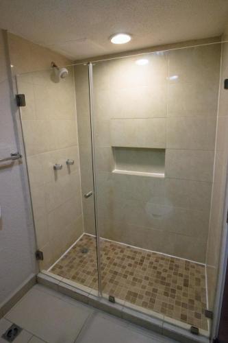 a shower with a glass door in a bathroom at CHN Hotel Monterrey Centro, Trademark Collection by Wyndham in Monterrey