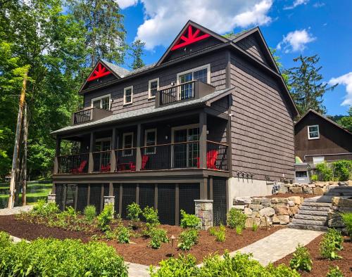 a black house with a red roof at Lakeside Lodging in Lake George