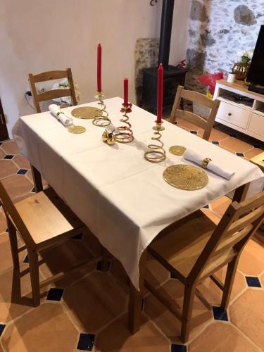 a table with two red candles on top of it at Finca La Sabina in Risco Blanco