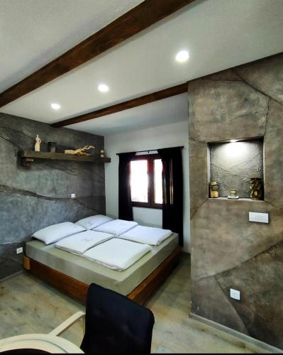a bedroom with a large bed and a window at Drinska laguna in Banja Koviljača