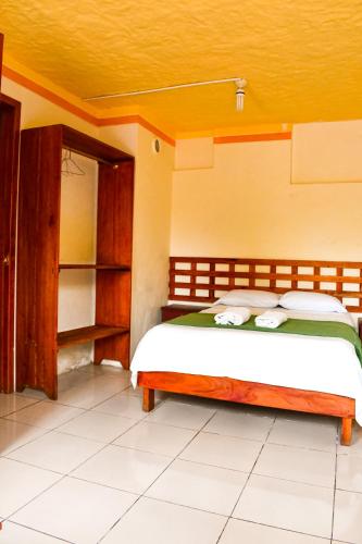 a bedroom with a bed and an open closet at Galapagos Dove in Puerto Ayora