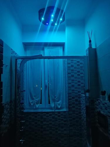 a room with a door and a blue light at Ad Un Passo Dal Mare in Savona