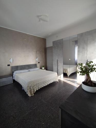 a bedroom with a large bed with a white bedspread at Ad Un Passo Dal Mare in Savona