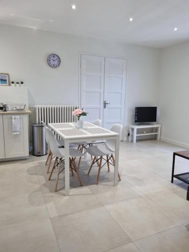 a white table and chairs in a room at "La Scierie" T4 80m2 Annecy in Annecy