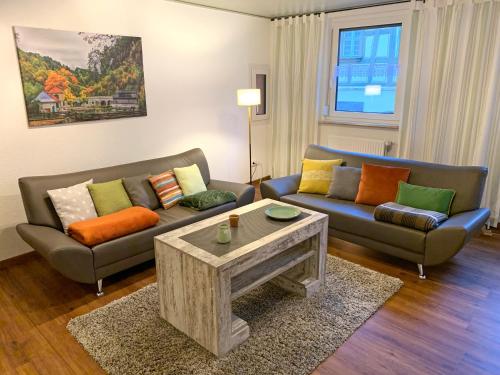 a living room with two couches and a coffee table at Villa Ammonit in Pottenstein